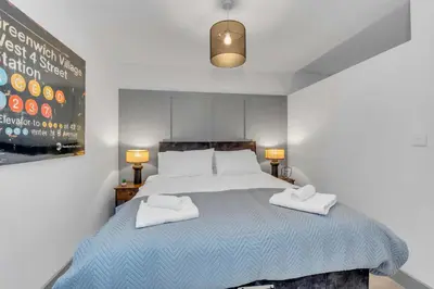 a bedroom with a bed with two towels on it at Cosy 1-Bed Apt in Newmarket with Parking in Newmarket