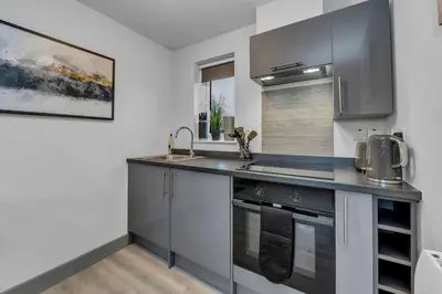 a kitchen with a sink and a stove at Cosy 1-Bed Apt in Newmarket with Parking in Newmarket
