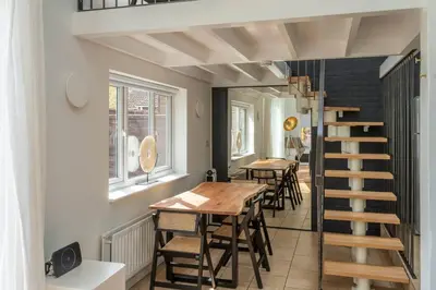 a room with a table and chairs and a staircase at Luxury self contained one bedroom - Sawbridgeworth in Sheering