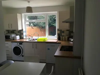 a kitchen with a sink and a washing machine at Cambridge Water House Apartments in Cambridge