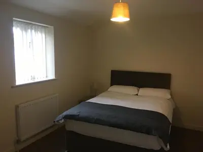 a bedroom with a bed and a window at Cambridge Water House Apartments in Cambridge