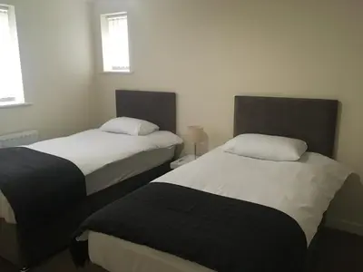two beds in a small room with at Cambridge Water House Apartments in Cambridge