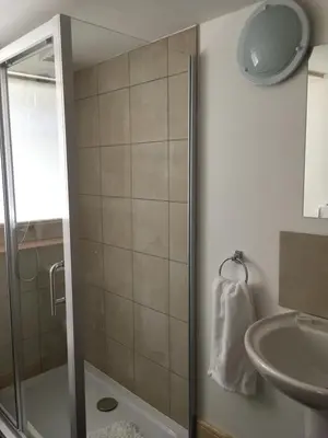 a bathroom with a shower and a sink at Cambridge Water House Apartments in Cambridge