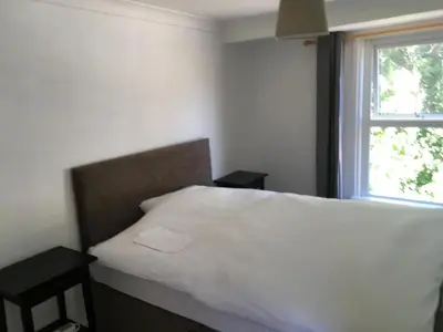 a bedroom with a white bed and a window at Cambridge Water House Apartments in Cambridge