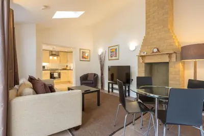a living room with a couch and a table at Cambridge Water House Apartments in Cambridge