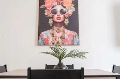 a painting of a woman with sunglasses and a plant at The House In Defoe Rd - 3br 1bath W Free Parking in Ipswich