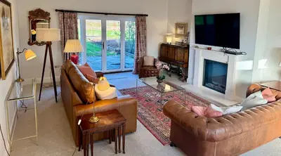 a living room with two couches and a fireplace at North Farm fits 1-6 people in Sawston