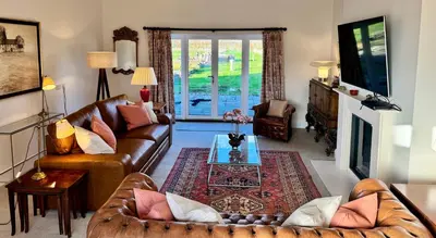 a living room with a couch and a table at North Farm fits 1-6 people in Sawston