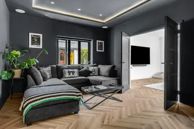 a living room with a couch and a tv at House of Hertfordshire in Datchworth