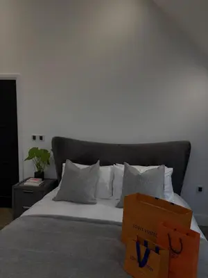 a box sitting on top of a bed with pillows at House of Hertfordshire in Datchworth