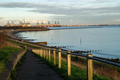a walkway next to a body of water with birds at Seaview House with Sea View Brand New- 3 Bedrooms - Harwich, Dovercourt in Lancing