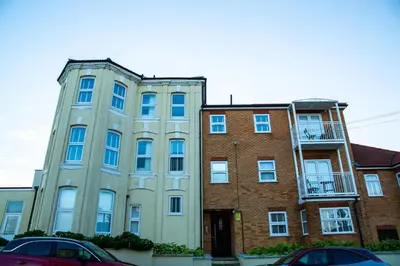 an old brick building with a balcony on it at Seaview House with Sea View Brand New- 3 Bedrooms - Harwich, Dovercourt in Lancing