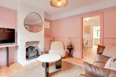 a living room with a fireplace and a mirror at Luxury Two Bedroom Cottage - Bishops Stortford in Bishops Stortford