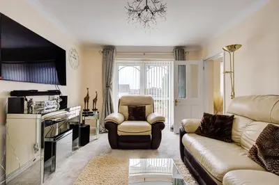 a living room with a couch and a chair at Luxury - 4 BHK Semi Detached House in Chelmsford