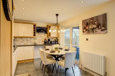 a kitchen and dining room with a table and chairs at Luxury - 4 BHK Semi Detached House in Chelmsford