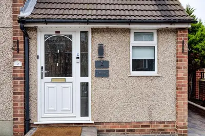 a brick house with a white door and two windows at Luxury - 4 BHK Semi Detached House in Chelmsford