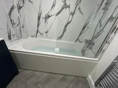 a bath tub in a bathroom with a marble wall at Next To Park 3 Bedroom V CENTRAL in Cambridge
