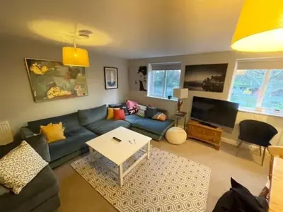 a living room with a blue couch and a table at Next To Park 3 Bedroom V CENTRAL in Cambridge