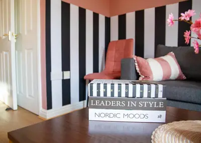 a living room with a couch and a table with books at 4x Bed Elegant Home with Parking in Ely