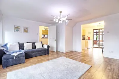 a living room with a couch and a rug at 4br 2bath House With Free Parking In Rivenhall in Rivenhall