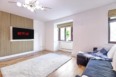 a living room with a couch and a tv at 4br 2bath House With Free Parking In Rivenhall in Rivenhall