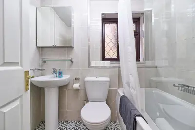 a bathroom with a toilet and a sink and a tub at 4br 2bath House With Free Parking In Rivenhall in Rivenhall