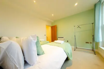 a bedroom with two beds and a glass door at Charlotte House 2bed 2bath Retreat For 6 Guests in Ipswich