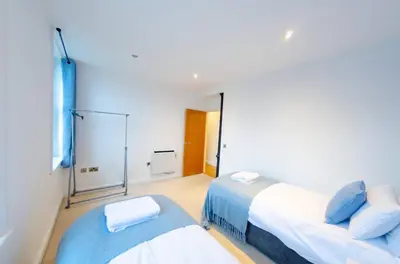 a bedroom with two beds and a window at Charlotte House 2bed 2bath Retreat For 6 Guests in Ipswich