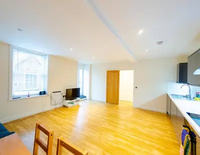 an empty kitchen and living room with a wooden floor at Charlotte House 2bed 2bath Retreat For 6 Guests in Ipswich