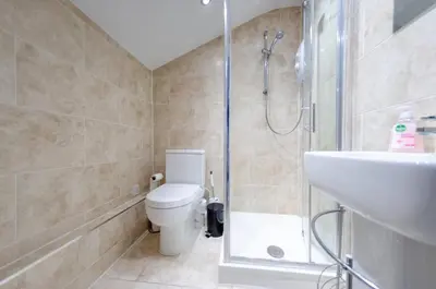 a bathroom with a shower and a toilet and a sink at 2br 2bath Flat In Ipswich City Centre - 6 Guests in Ipswich