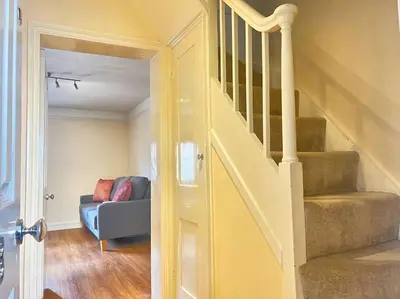 a living room with a staircase and a couch at 2br 2bath Flat In Ipswich City Centre - 6 Guests in Ipswich
