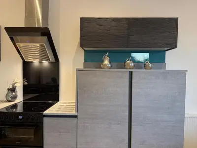 a kitchen with a stove and a stove top oven at Beautiful 2 Bedroom Barn -Stansted Airport 2 miles in Elsenham