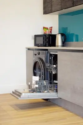 a washing machine in a dishwasher in a kitchen at Beautiful 2 Bedroom Barn -Stansted Airport 2 miles in Elsenham