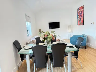 a dining room with a table and chairs at Beautiful 2 Bedroom Barn -Stansted Airport 2 miles in Elsenham