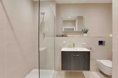 a bathroom with a shower and a sink and a toilet at Castle Hill Apartments Colchester in Colchester