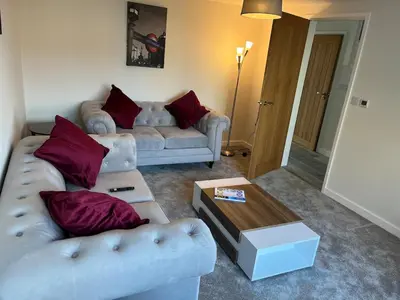 a living room with two couches and a coffee table at Mango Cottage in Thorndon