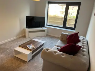 a living room with a couch and a coffee table at Mango Cottage in Thorndon