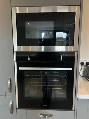 a microwave oven sitting inside of a kitchen at Mango Cottage in Thorndon