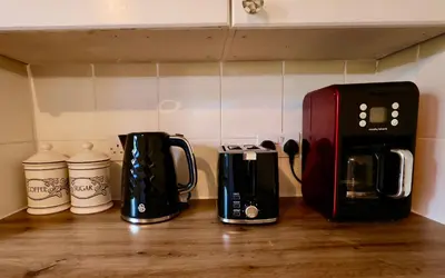 two coffeemakers sitting on top of a kitchen counter at Deben Cottage, Central Woodbridge in Woodbridge
