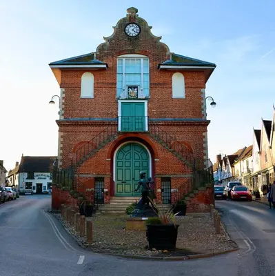 a red brick building with a clock on it at Deben Cottage, Central Woodbridge in Woodbridge
