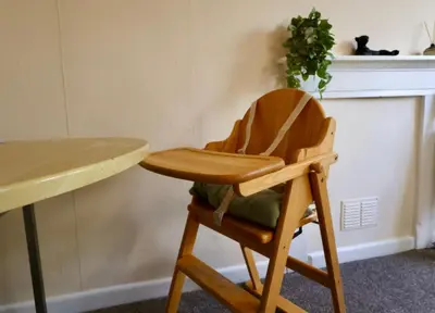 a wooden chair sitting next to a table at Deben Cottage, Central Woodbridge in Woodbridge