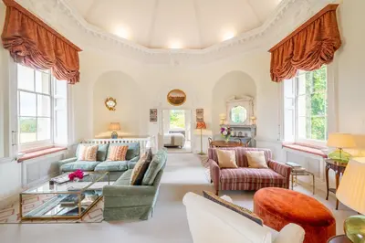 a living room with a couch and a table at A Duke's Spectacular grand folly - The Temple in Euston