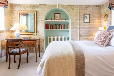 a bedroom with a bed and a table and a desk at A Duke's Spectacular grand folly - The Temple in Euston