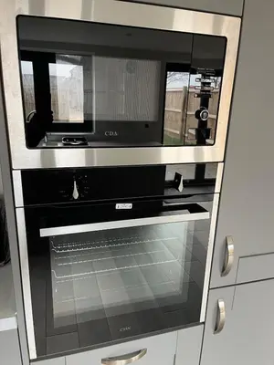 a microwave oven sitting inside of a kitchen at Pineapple Cottage in Thorndon