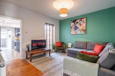 a living room with a couch and a tv at Stylish 3-Bed Home in the Heart of the Cambridge in Cambridge