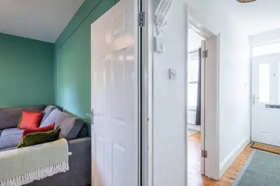 a living room with a couch and a sliding door at Stylish 3-Bed Home in the Heart of the Cambridge in Cambridge