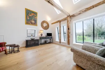 a living room with a couch and a table at The Stable Barn, Smallwood Farm House in Hessett