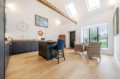 an open kitchen and dining room with a table and chairs at The Stable Barn, Smallwood Farm House in Hessett