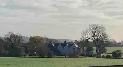 a group of houses in a field with trees at Grade 1 Listed Farm House 14 ppl 45 mins London in Fyfield