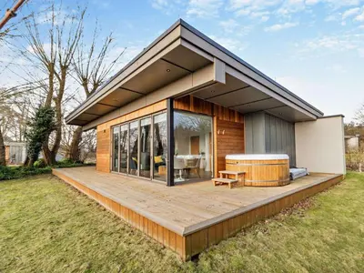 a house with a large deck with a hot tub at 2 Bed in Colchester oc-95941 in East Bergholt